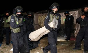Non-violent Palestinian protesters being removed from the tent city of Bab al-Shams